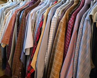 Closet full of very nice mens shirts.