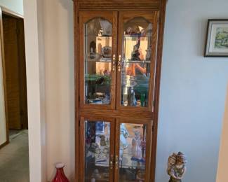 Curio filled with nest of dolls, fenton, Jaedite, Lenox, an antique smoker and more.