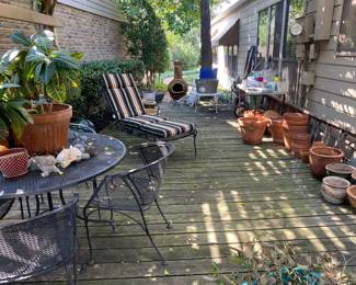 Patio filled with treasures including a Chimenea, terra cotta pots, Wrought Iron Table and Chairs, 