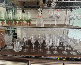 Set of 8 watermelon glass glasses. Set of 3 Waterford wine glasses. Set of 4 Waterford short wine glasses. Collection of marquee by Waterford on the second shelf.