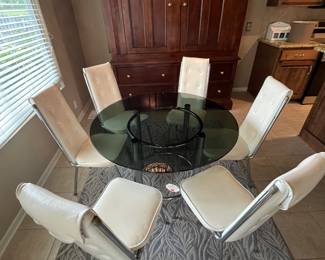 Mid-century modern glass top table with chrome base and six chairs