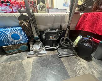 3 vacuums with accessories. Oreck canister vacuum. Rainbow, vacuum and Kirby, power driven vacuum.