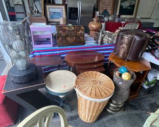 Z table, marble top round table, large wicker hamper, three nesting tables, ottoman, Ethan, Allen end table, and two metal vases with decorative balls.