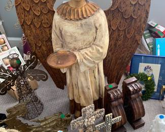 Large wooden angel, various Christmas and religious decorations.