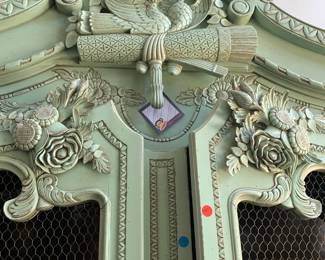Carving on top of armoire.