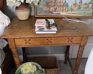 Pine side table with carvings.