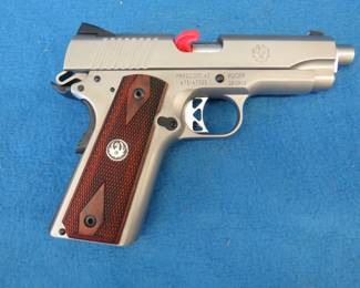 Lot 29. New in the box stainless Ruger SR1911 45 auto pistol. Includes factory case, two magazines, manual, barrel key, and a gun lock. Never fired.
