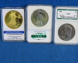 Lot 344. 1776-1976 Eisenhower dollar (ANI MS66). 1984 Olympic 90% silver dollar graded ANI MS 70. 24k gold-layered copy of a 1933 Gold Double Eagle.