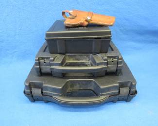Lot 242. Three gun cases and a S & W leather holster for a Colt Single action