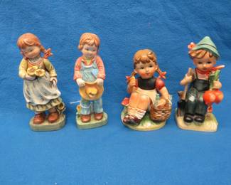 Lot 33. Two sets of boy and girl ceramic figurines