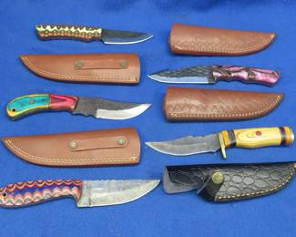 Lot 358. Five new knives. Three are Damascus and all five have leather sheaths.