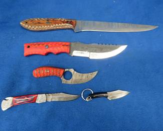 Lot 356. Five new knives with leather sheaths, four are Damascus. No markings