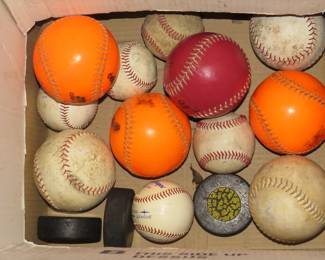 Lot 210. Softballs, baseballs, and hockey pucks.