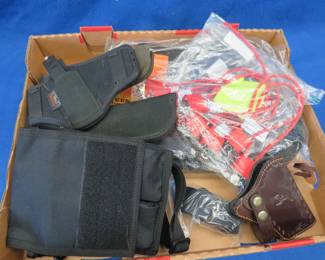 Lot 187. Holsters, gun locks, a gun case, and more