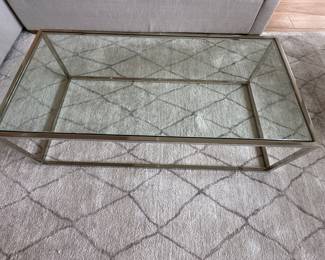 Restoration Hardware Nicholas metal and glass coffee table; 24" d x 48" l x 14" t; $550; Restoration Hardware area rug; 9' x 12'; $700