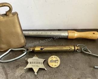 Cow bell, brass scales, metal Marshall badge, Sawyer Brown pin, ring sizer