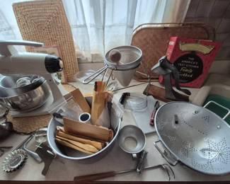 Vintage Kitchen. Inside the cake pan are Campbells soup spoons new in package.