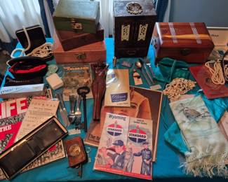 Another table with some jewelry along with vintage travel items.  The wooden woman in the center of the picture is a nutcracker. (it cracks me up!) The scarf is pure silk hand painted in Japan.  The flatware is from Delta airlines and Northwest Orient. Multiple jewelry boxes.  Cross Morph, Shadyrays and 7eye sunglasses.