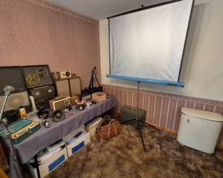 Vintage electronics, movie screen and hamper.