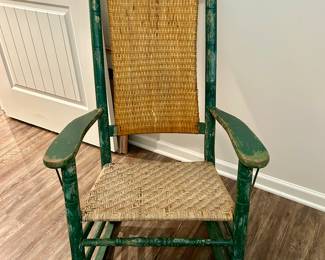 Vintage Ladder-Back Rocking Chair
Classic wooden rocking chair with woven rush seat and back. Features an aged green painted finish with natural wear, giving it farmhouse character and rustic charm. Perfect for porch sitting, cabin décor, or as a cozy accent piece.