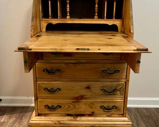 Rustic Pine Secretary Desk
Solid knotty pine drop-front secretary desk with four drawers and brass hardware. The hinged writing surface opens to reveal cubbies and compartments, perfect for organizing papers, stationery, or small items. Classic farmhouse/rustic style with attractive wood grain and warm natural finish.