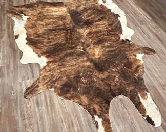 Large Genuine Cowhide Rug – Brindle Brown & White
Beautiful full-size genuine cowhide rug in a brindle brown and white pattern. Soft, durable, and naturally unique, this piece adds warmth and western character to any living room, office, or lodge space. Can be styled as a floor covering or used as a dramatic wall hanging.

Condition: Excellent, supple hide with no major flaws.

Dimensions: Approx. 7’ L x 6’ W (varies by natural shape)