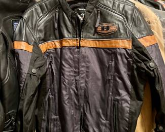 Harley-Davidson men’s textile and leather riding jacket with orange stripe and embroidered logos. Zip vents, adjustable waist, excellent condition.