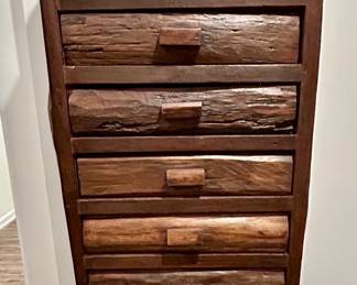 Rustic Log-Style Tall Chest with Multiple Drawers
Unique handcrafted tall chest featuring log-style drawer fronts and a dark-stained finish. With its vertical design and multiple drawers, this piece offers both storage and rustic charm, perfect for a lodge, cabin, or western-inspired home.

The organic texture of the wood and handcrafted details make it a standout statement piece while still serving as practical storage.

Condition: Very good, sturdy and solid with minor wear consistent with rustic craftsmanship.

Dimensions: Approx. 72” H x 24” W x 16” D