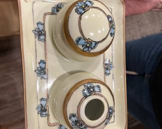 Antique Hand-Painted Bavarian Porcelain Vanity Set (1915, Signed)
Charming Bavarian porcelain dresser/vanity set, hand-painted with soft blue flowers and gilt accents. Includes tray and two lidded jars. Signed Helen Morris and dated 1915 on the underside, with Bavaria mark. Typical of early 20th-century Bavarian blanks hand-painted by skilled hobbyists. Excellent condition for age with only minor expected wear.
	•	Date: 1915
	•	Origin: Bavaria porcelain blank
	•	Pieces: Tray + 2 jars