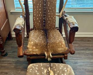 Rustic Deer Hide Rocker with Ottoman
Handcrafted wooden rocking chair with matching ottoman, upholstered in genuine axis deer hide. Unique lodge-style design featuring antler accents on the arms and headrest. A true statement piece for cabin, lodge, or trophy room décor.