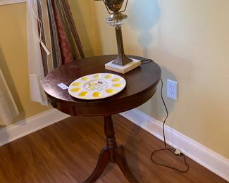 Small, round, wooden table.