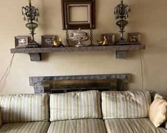 Midcentury couch, vintage lamps, brass candlesticks, gold tone decor