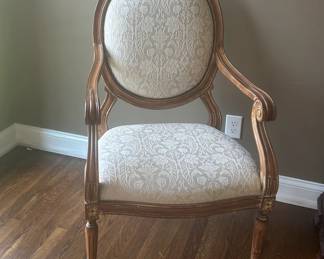 2 Oval back Arm Chairs. Carved pecan, lightly distressed with highlighted features. H - 45" W - 27" D - 22". Chair seating height - 18"