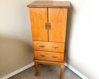 Vintage Jewelry Armoire
Tall oak armoire with double doors and two drawers. Traditional design with Queen Anne legs. Great for jewelry or small storage.