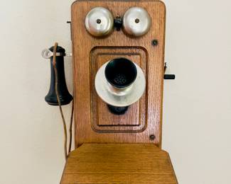 Vintage Wooden Wall Telephone 
Charming oak wall-mounted crank telephone with metal bells and earpiece. Great as a display piece, conversation starter, or antique collection 