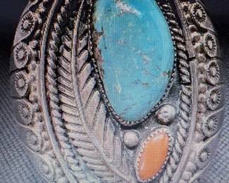 Turquoise and coral specimens enhance the face of the large and lovely cuff. Pictures do not do the jewelry justice. For more details go to: https://modestlambestatesales.hibid.com/