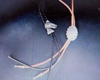 Bolo ties. Pictures do not do the jewelry justice. For more details go to: https://modestlambestatesales.hibid.com/
