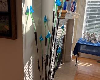 In the style of Jesse Kelly Blue Chivas Plant.  Each bloom is sitting in a glass vial.  Approx 5.3" tall.