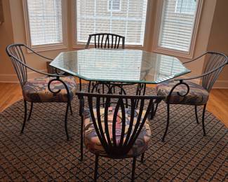 Wonderful Contemporary hexagon glass top table with Iron Base and 4 matching Iron Slat back arm chairs.  Very comfortable.  Round  patterned rug.