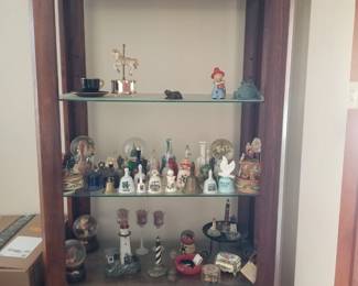 Miniature bells, lighthouses and decor; etagere with glass shelves