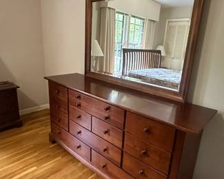 Beautiful wooden dresser with lots of storage and a mirror
