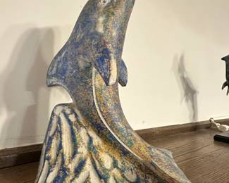 Dolphin sculpture titled "Out of the Blue" by artist Barry Stein