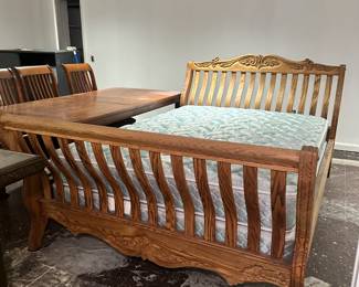 King-size solid oak sleigh bed with beautiful details. There's also a matching dresser and side tables. 
