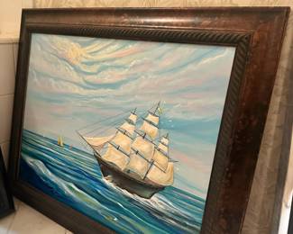 Framed painting of a sailing ship on the open sea