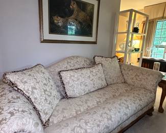 This classic-style rolled arm sofa is part of a lovely living area furniture suite. It has reversible pillows.  
