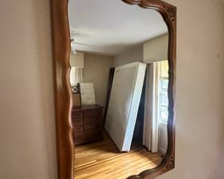 large, ornate wooden-framed wall mirror