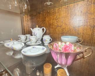 Tea set and adorable pink tea cup with floral print.