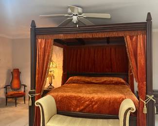 King-sized bed with canopy - A bed a king could love. Hand-carved wood with glass ceiling, velvet drapery, and bedspread to match. From His Elvis area