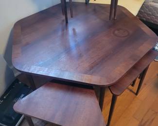 Awesome midcentury modern Danish walnut coffee table with 6 triangular nesting tables underneath.