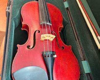 French Violin, circa 1880. The top is made of two pieces of finely grained spruce. The varnish is a vibrant red color on golden ground. 